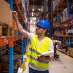 Professional warehouse worker protective work wear holding checklist checking inventory storage room 342744 1563 1 qec76z4voegt9umrw01bbti564wr42g6q8rzp965ww